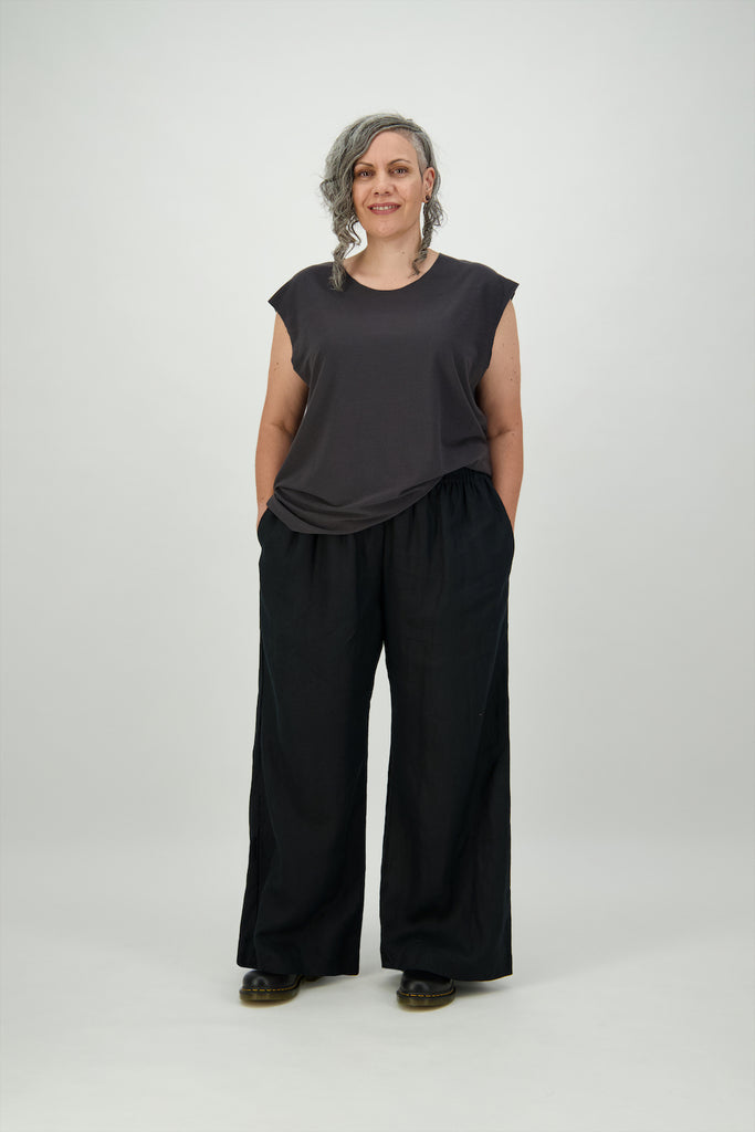 Front view woman wears high waisted black linen pant with hands in pockets Citizen Women