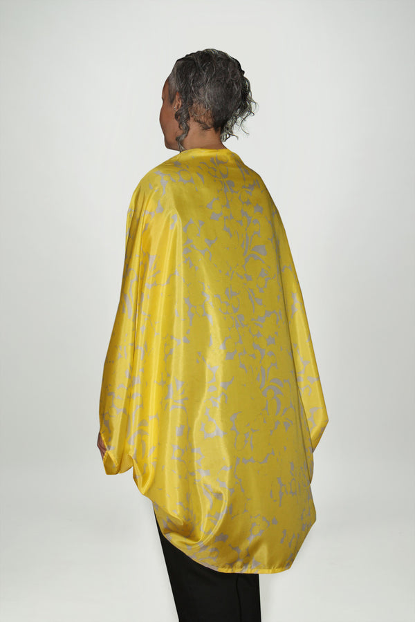 Back view of woman wearing a long, draped yellow Shrug, Citizen Women