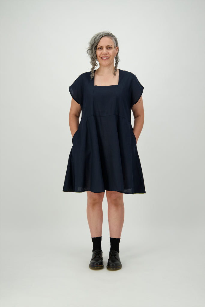 Woman wearing Navy square neck dress with hands in pockets Citizen Women