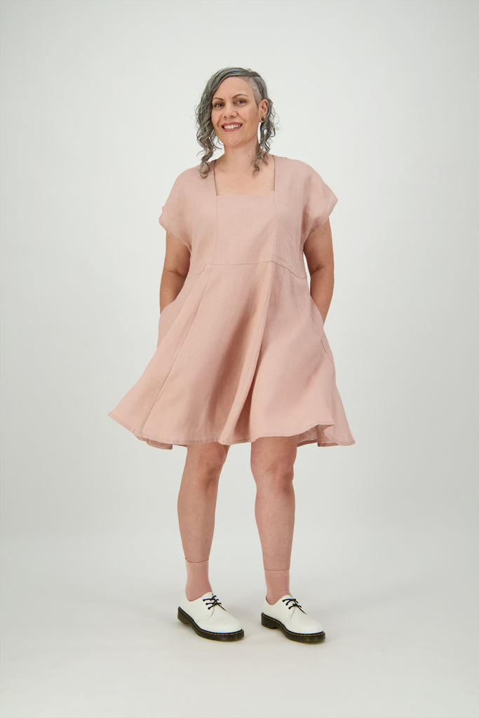 Woman wearing rose coloured linen square neck dress with side pockets Citizen Women