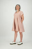 Three quarter view woman wears rose coloured dress with flared skirt Citizen Women