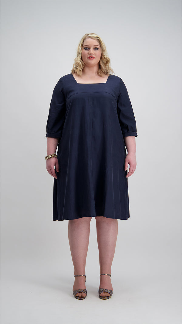 Woman wears navy coloured flared square neck dress Citizen Women