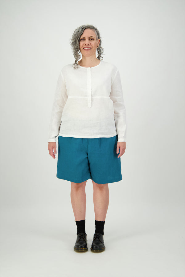 Woman wears teal linen, roomy knee length shorts, with white shirt, Citizen Women