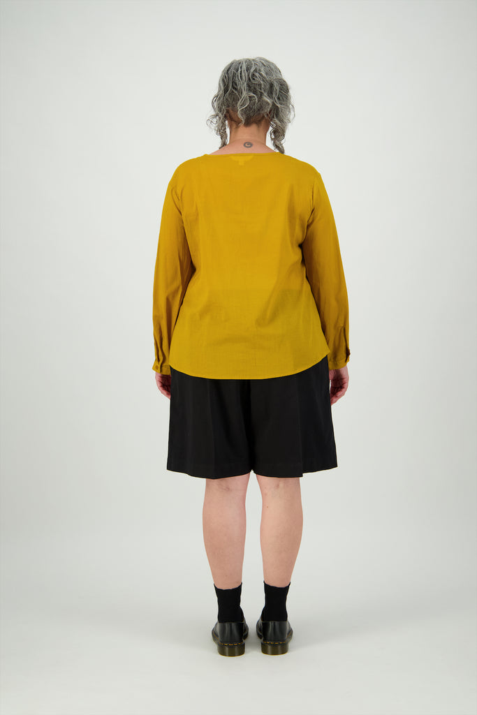 Back view woman wearing mustard cotton top with shorts Citizen Women 