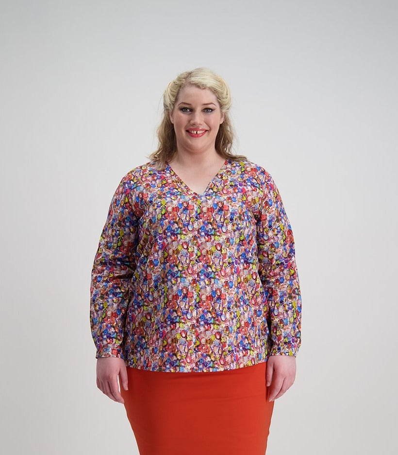 Woman wears multi colored jewel patterned V neck top with front seam Citizen Women 