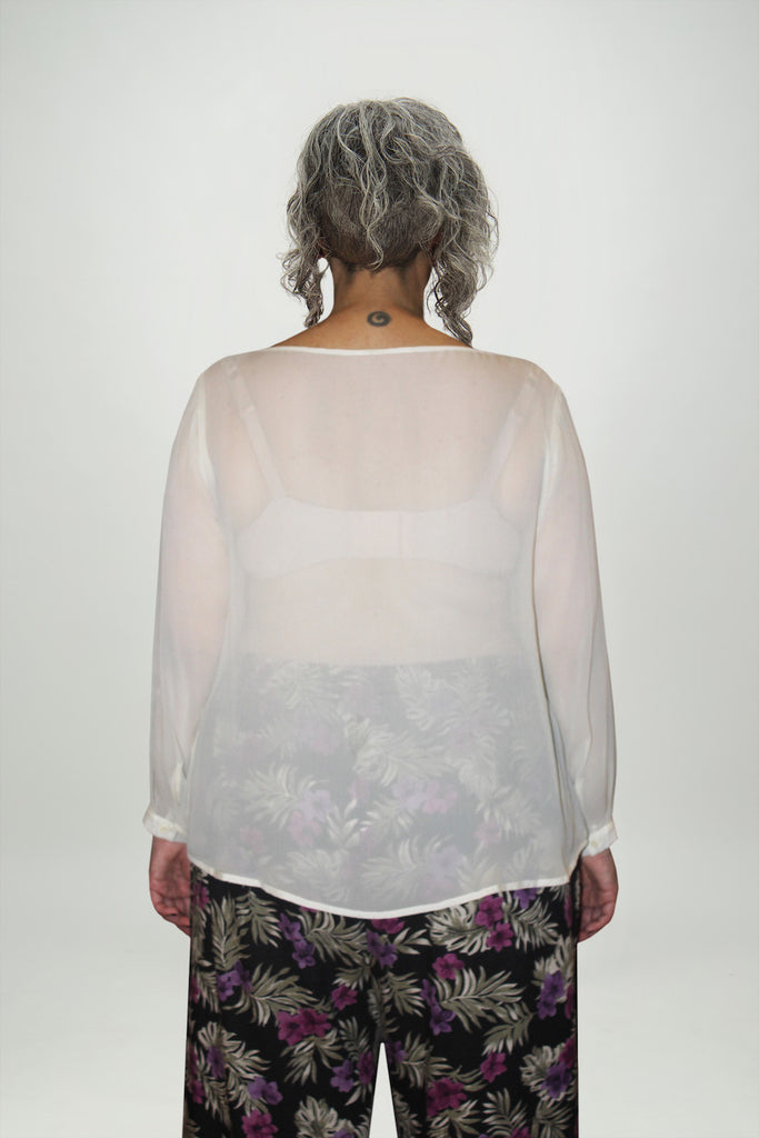 Back view woman wears translucent cream silk top and floral Resort pants Citizen Women 