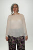 Woman wears cream boat neck top, long sleeve with button cuff Citizen Women 
