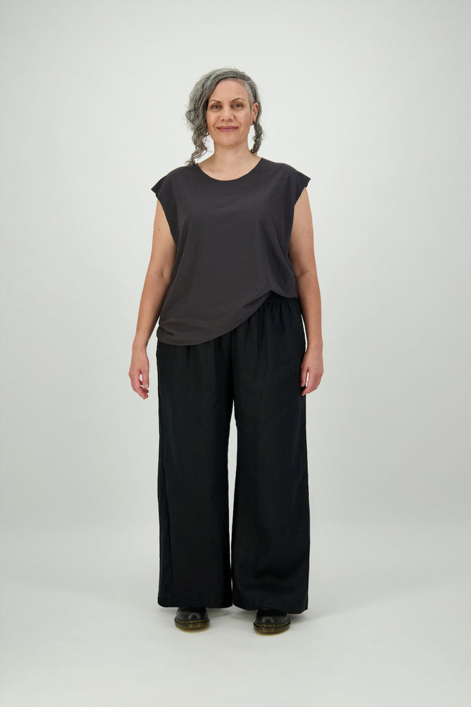 Woman wears long wide straight leg black pants with wide waistband Citizen Women