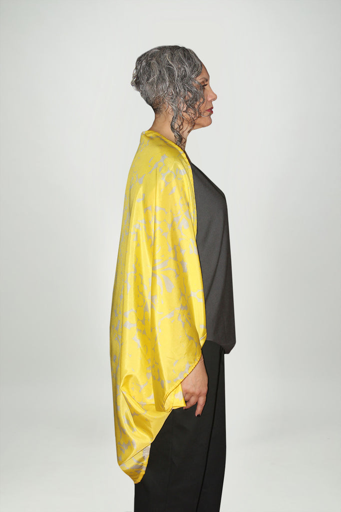 Side view of a woman wearing a one size fits all, long sleeve shrug, Citizen Women