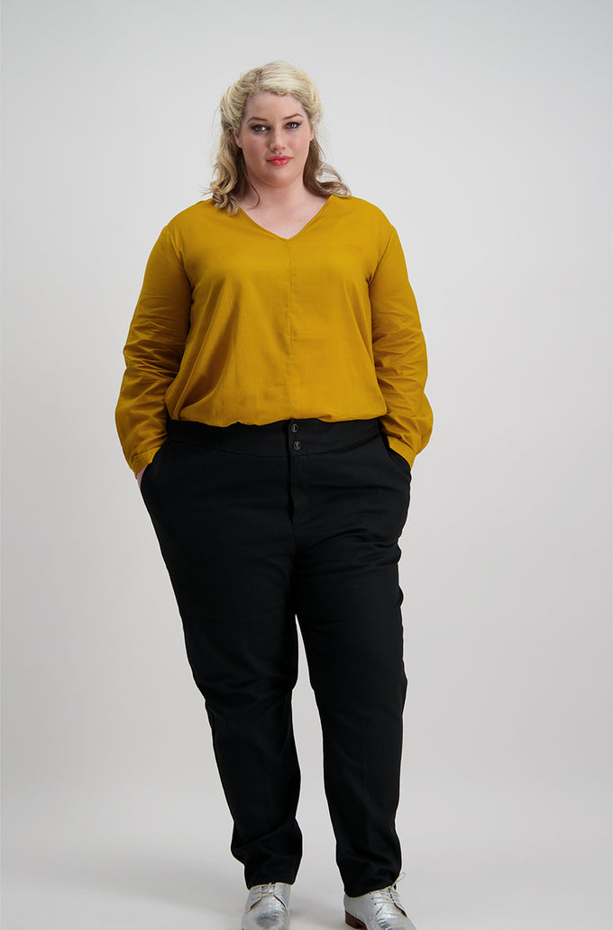 Woman wears black trousers with a wide two button waistband, Citizen Women